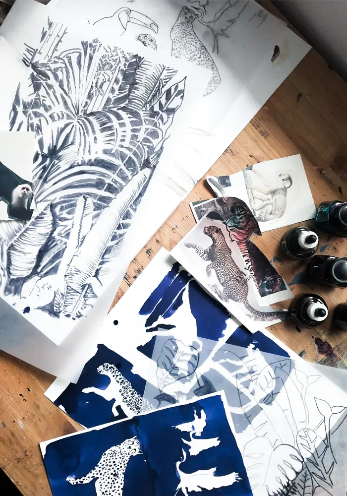 Se muestran diferentes diseños y pruebas para la preparación de serigrafía en una mesa, los motivos son animales